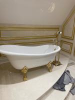 white freestanding bath with tile wall