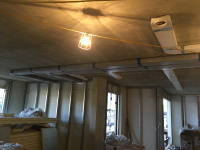 Ventilation duct system routed across exposed ceiling